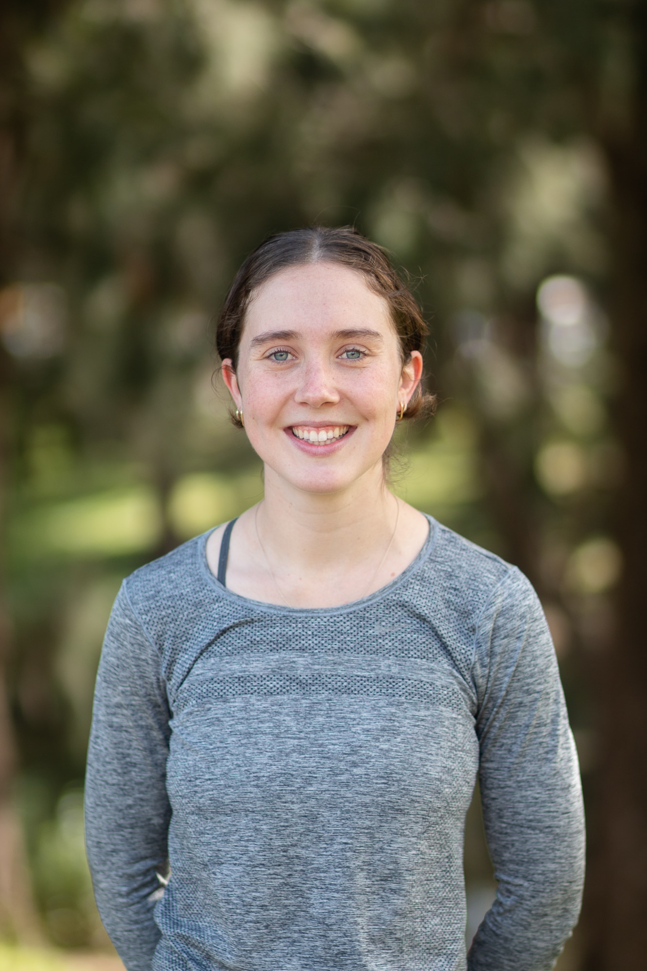 A young woman smiles at the camera