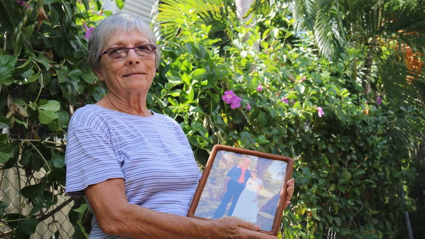 Judy Dent holds a picture of her late husband, Bob Dent