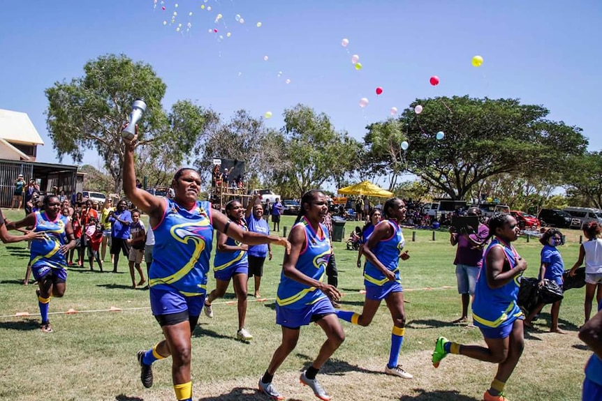 Looma football team celebrate as they play their grandfinal.