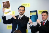 Amnesty International East Asia Director Nicholas Bequelin (left) holds up the report.