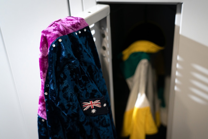 A leotard hangs over a locker door.