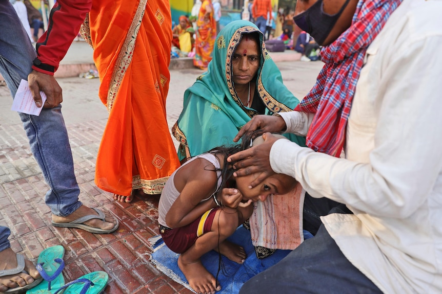 A young boy getting his head tonsured