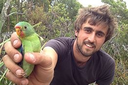 Dejan Stojanovic, conservation biologist, with a swift parrot.