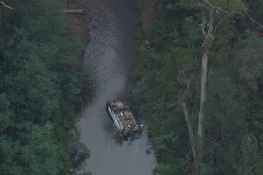 An overturned car in a river 