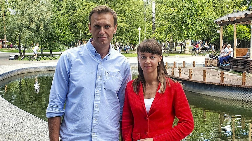 Ksenia Fadeyeva posting for a picture next to Alexei Navalny