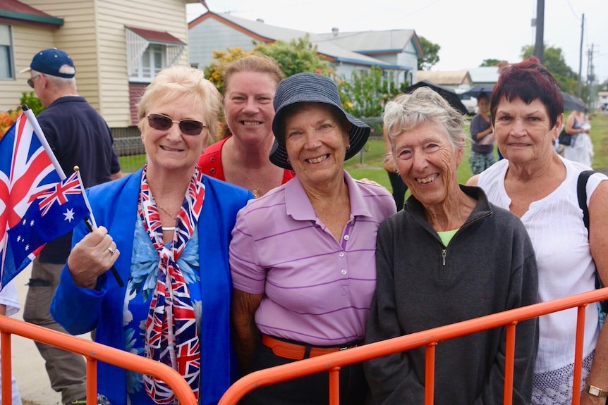 A group of women wait for Prince Charles to arrive at the Bundaberg Rum Distillery