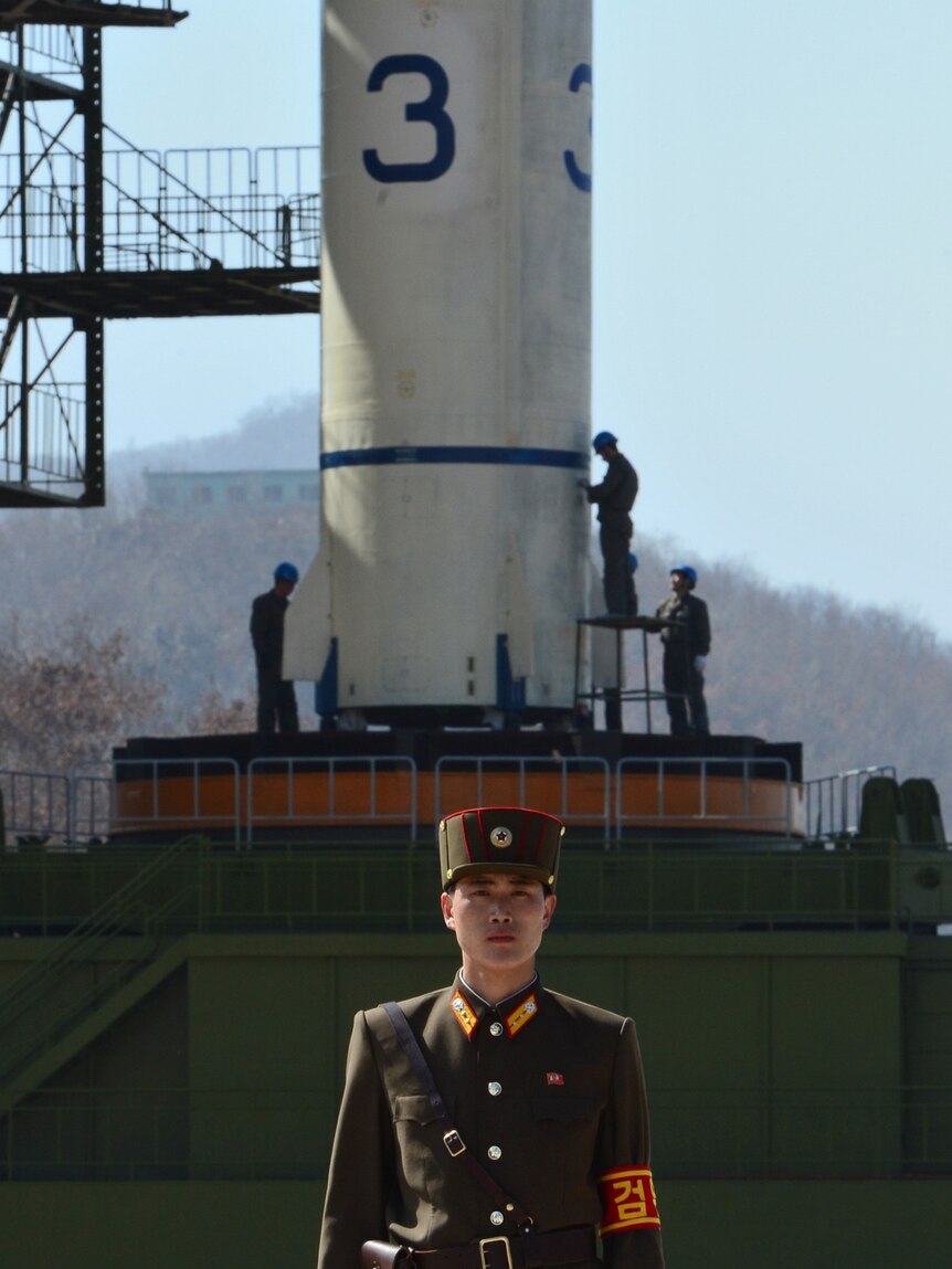 A North Korean soldier guards the Unha-3 rocket