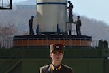 A North Korean soldier guards the Unha-3 rocket