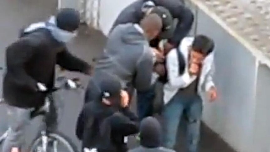 A bashed man is helped to feet, then robbed, during London riots