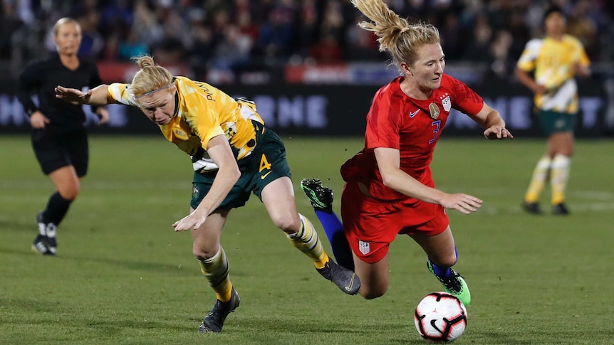 Clare Polkinghorne stumbles to the ground with her arms up as Sam Mewis (in red) also falls to the ground