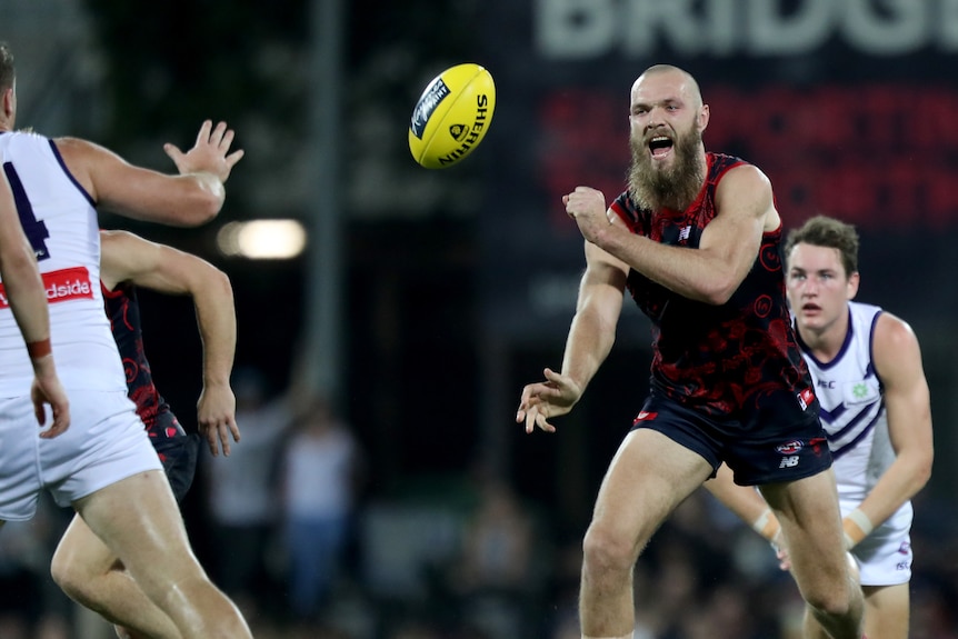 Max Gawn makes a handpass for the Demons against the Dockers.