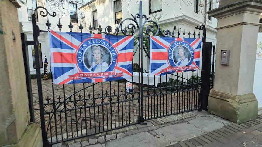 Signs featuring an image of the Queen and the words Queen Elizabeth: Platinum Jubilee appear on the gates of a home.