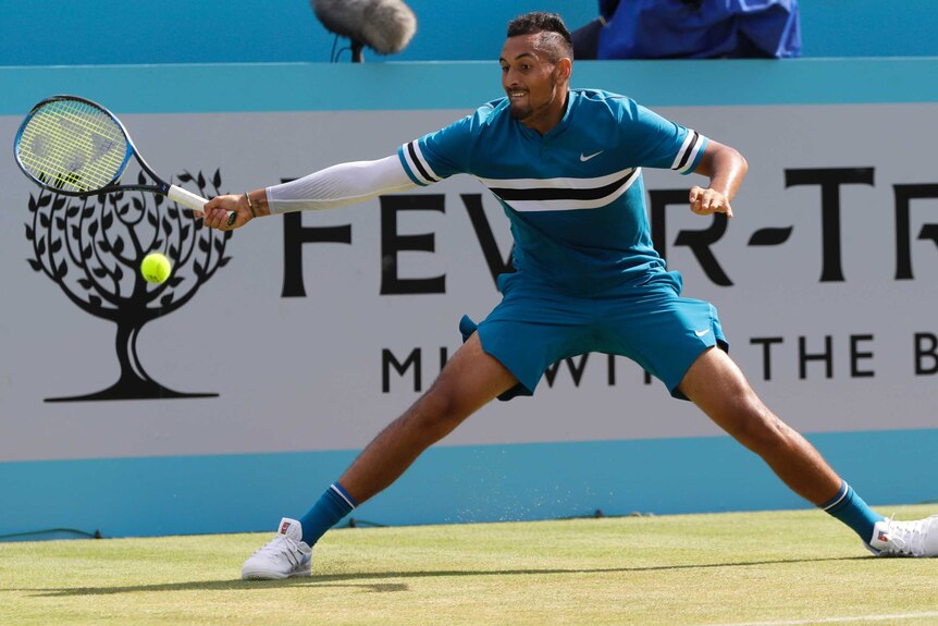 Nick Kyrgios of Australia plays a return to Kyle Edmund of Britain at Queen's Club on June 21, 2018.