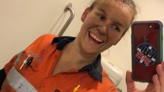 Vashti Arndt taking a selfie inside a toilet cubicle