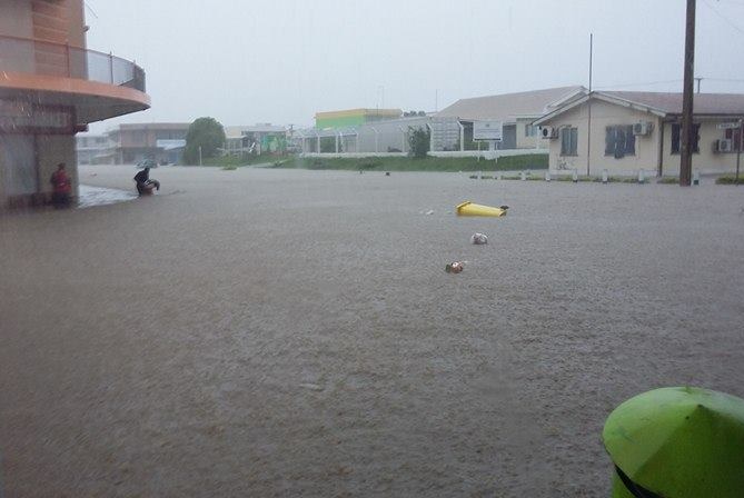 Waist-height water fills the main street of a town.