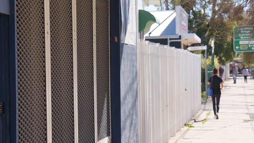 Walgett streetscape, with bars on a window in the foreground.