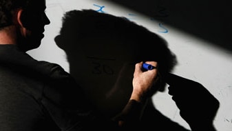 File photo: A teacher writing on a white board (Getty Images: Christopher Furlong)