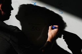 File photo: A teacher writing on a white board (Getty Images: Christopher Furlong)