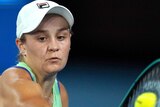 A tennis ball hits the racket of Ash Barty during her first Australian Open match.