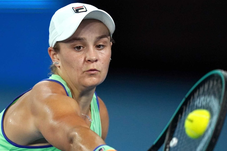 A tennis ball hits the racket of Ash Barty during her first Australian Open match.