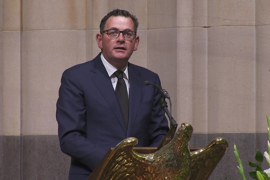 Victorian Premier Daniel Andrews stands behind a lecturn.