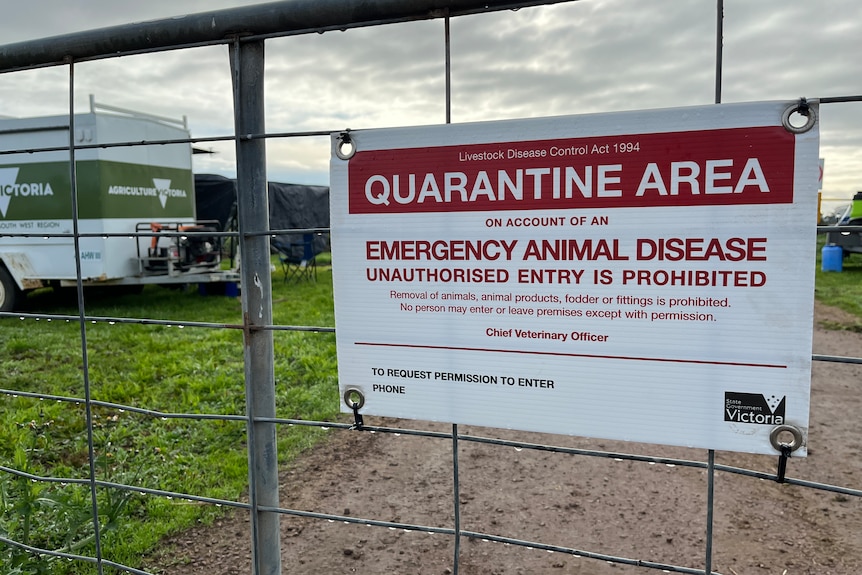 A quarantine sign on a farm gate.