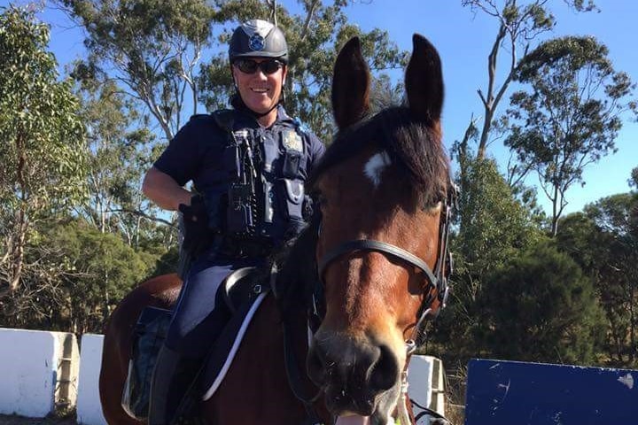 Senior Constable David Masters sits on his horse as part of his job with the mounted unit.