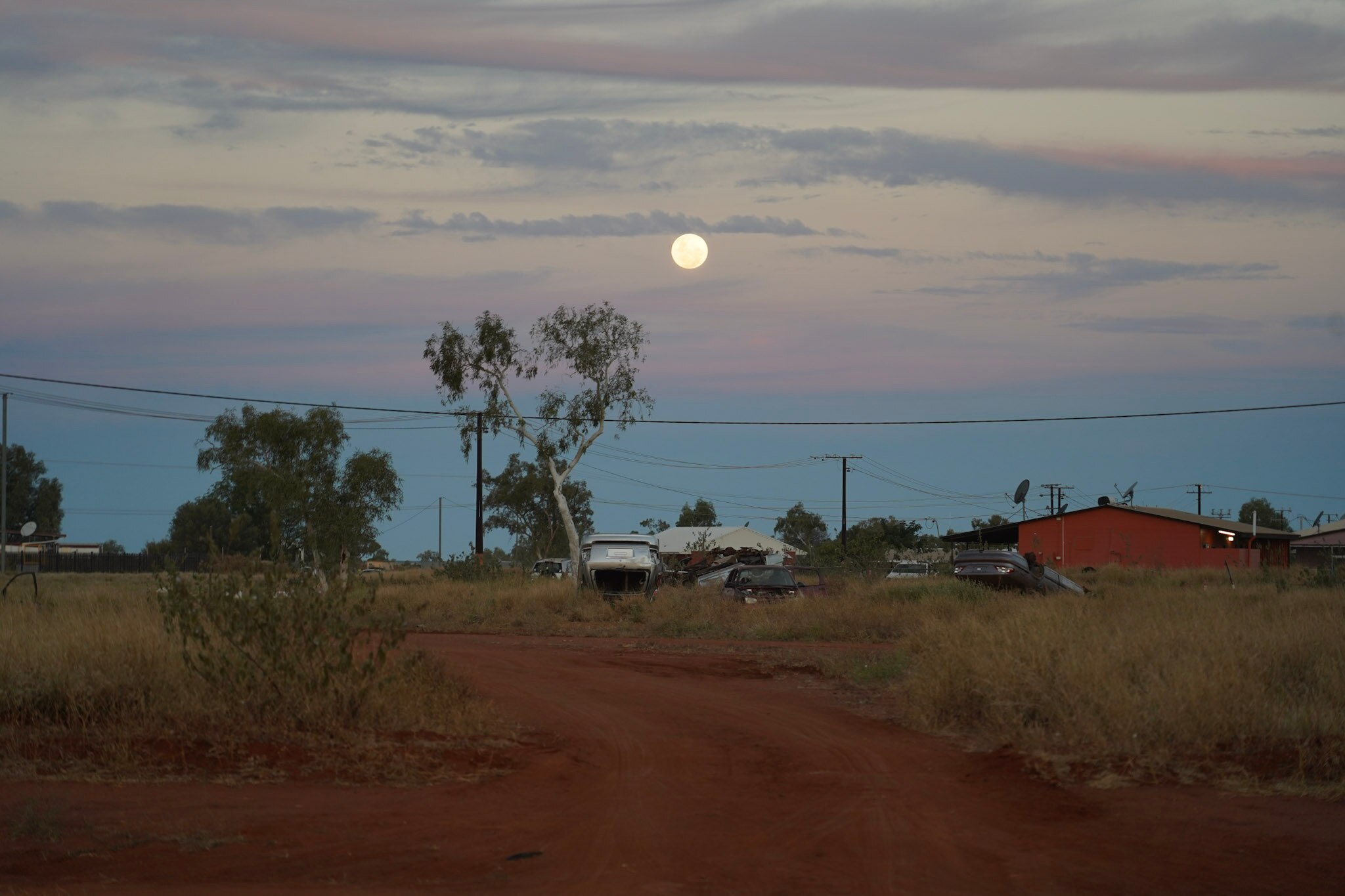 Full moon against pink and purple sky