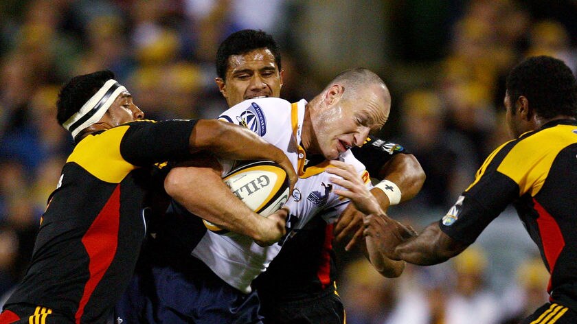 No room to move... Stirling Mortlock was wrapped up heavily by the Chiefs.