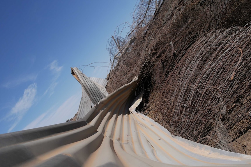 Bundles of crumpled metal fencing.