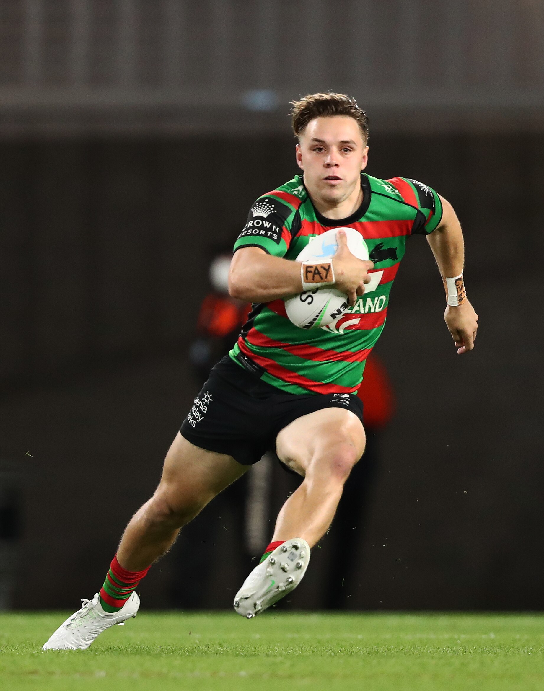 Rugby league player running the ball during a match