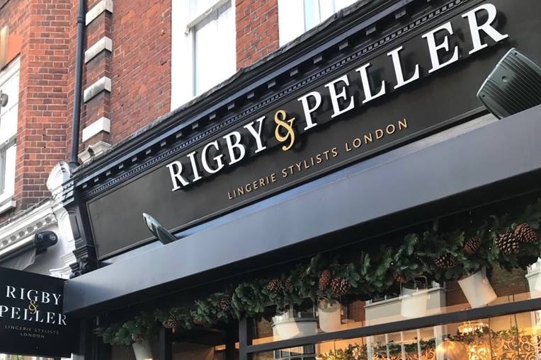 The Rigby & Peller shopfront painted black and decorated with greenery and mannequins in lingerie