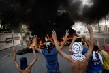 Bahraini protesters flash victory signs