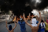 Bahraini protesters flash victory signs