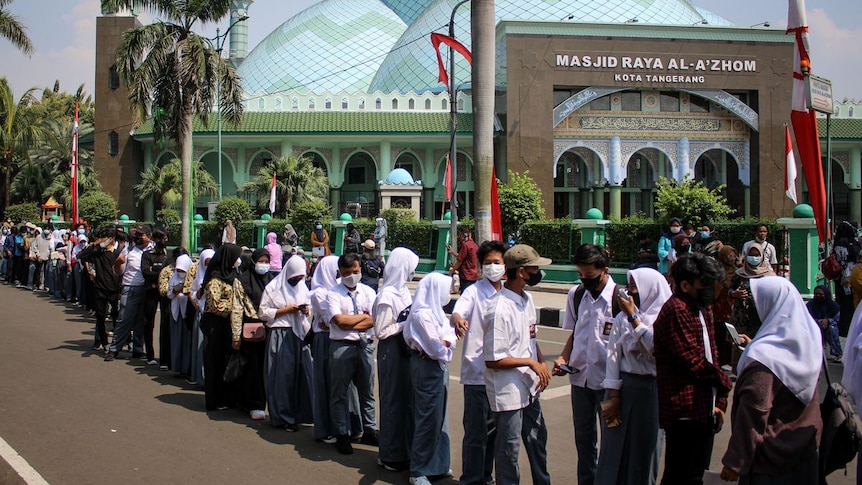 students lining up for a vaccination in Indonesia