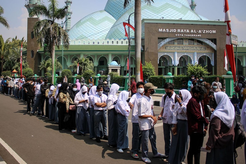 students lining up for a vaccination in Indonesia
