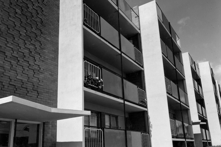 a balck and white of four-storey flats