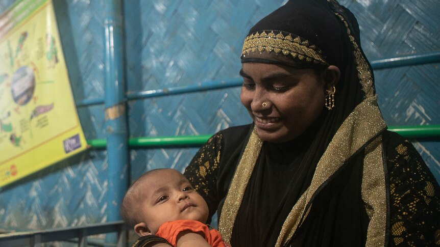 A woman with her baby in Cox's Bazar refugee camp in Bangladesh.