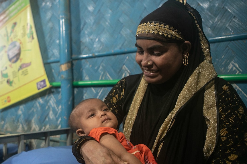 A woman with her baby in Cox's Bazar refugee camp in Bangladesh.