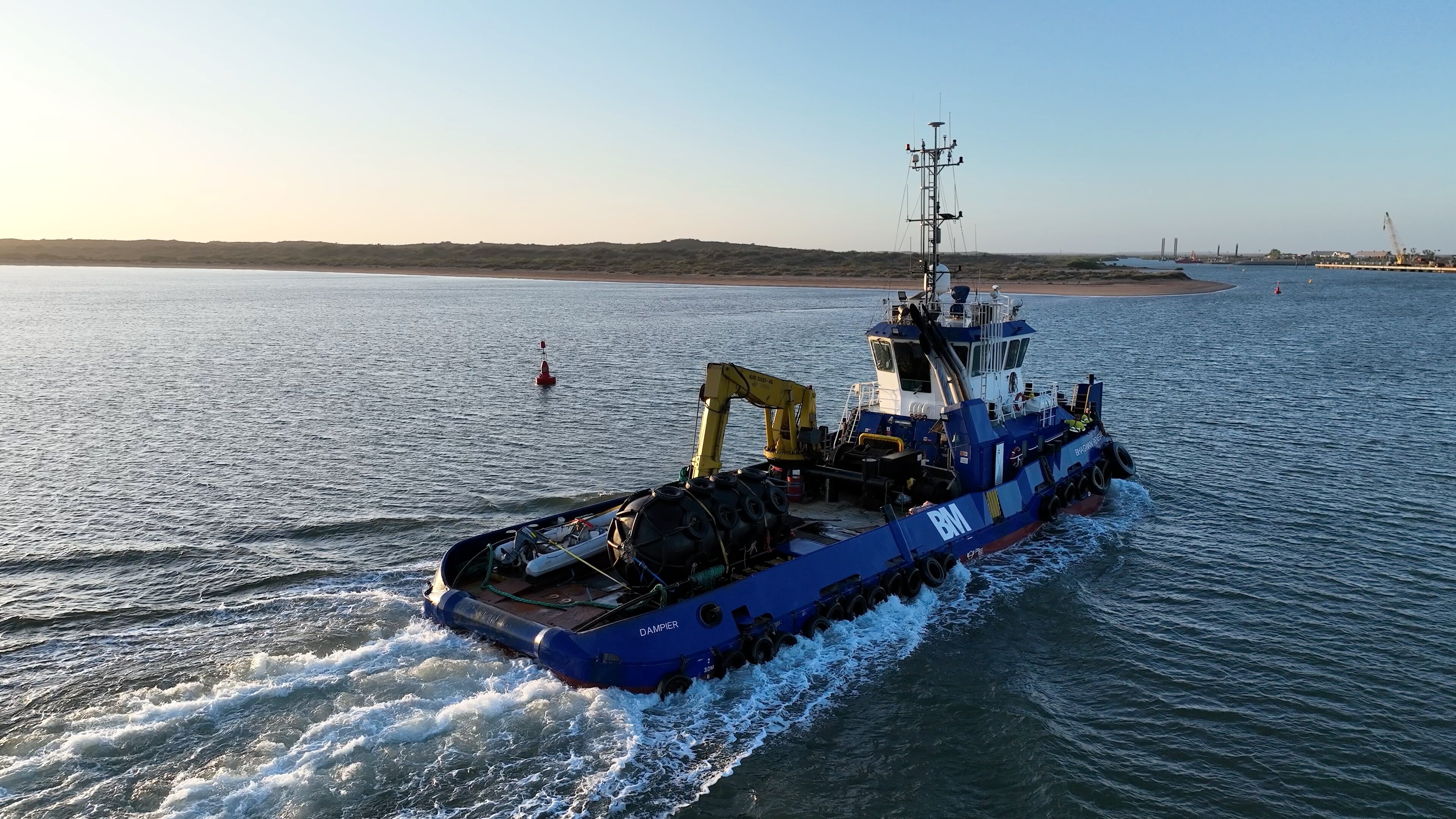 A ship with a large crane and fender on the back deck.