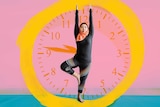 A woman exercises in front of an image of a clock to depict how to stick to fitness goals and daily exercise habits.