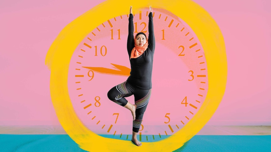 A woman exercises in front of an image of a clock to depict how to stick to fitness goals and daily exercise habits.