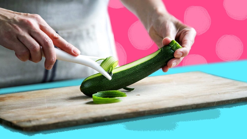 Chef peeling zucchini in the kitchen for a story about 7 recipe steps you can skip to save time when cooking