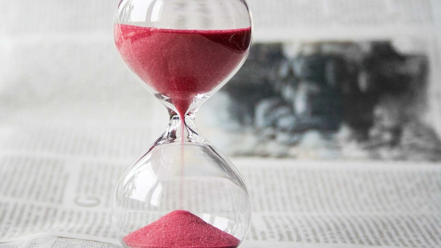 An hourglass with pink sand