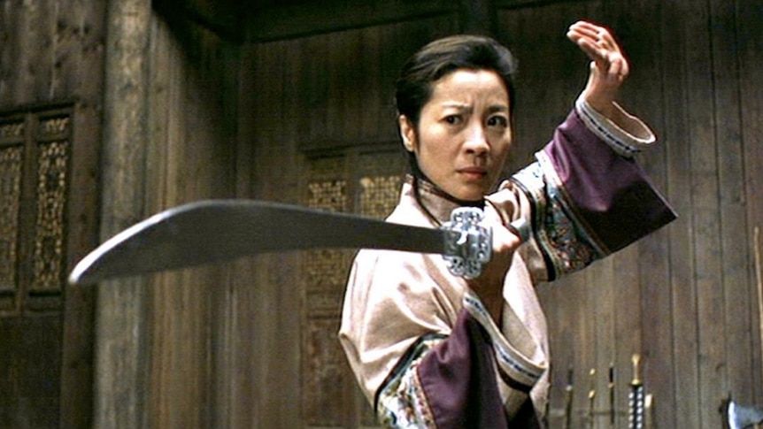 Michelle Yeoh holds a sword