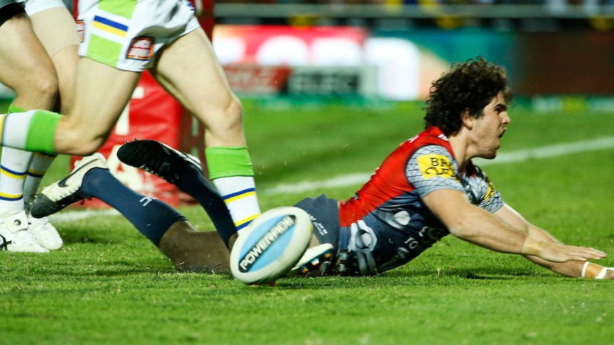 The Cowboys' Jake Granville scores a try against Canberra