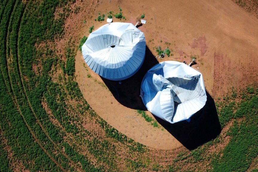 A drone shot of two cyclone-damaged silos from above.