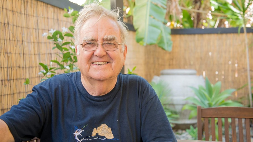 Lyall Forde relaxes in the garden at the rear of his Cairns home.