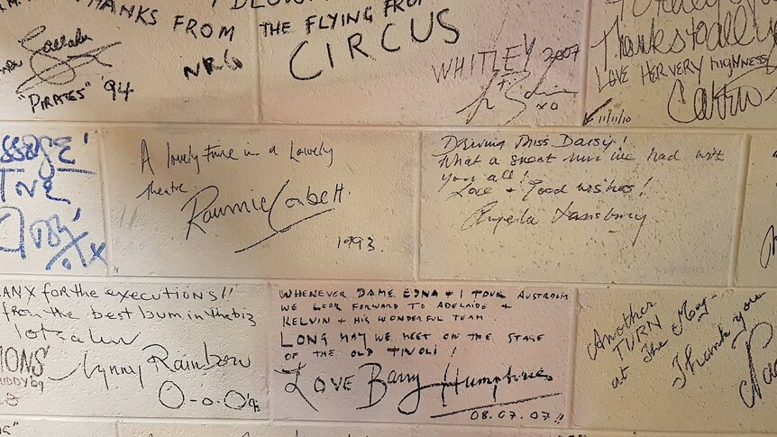 Celebrity signatures on the wall of Her Majesty's Theatre.