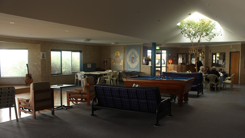 Inside the Mission to Seafarers, with pool tables, comfortable chairs, a guitar, and a skylight.